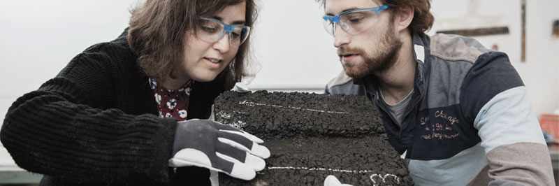 Photo. Two researchers working in asphalt lab.