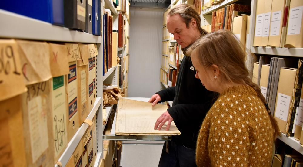 Two persons in a historical archive. Photo