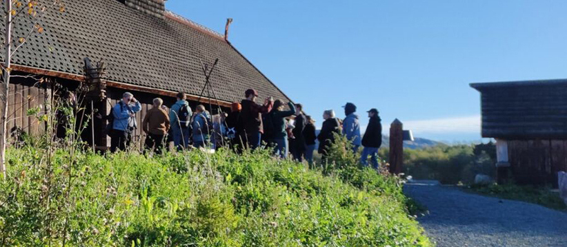 Students standing by a traditional building.