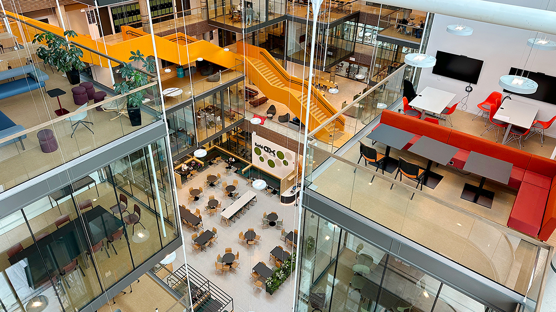 Photo indoors of a high room with many stairs and colorful interior. Photo: NTNU