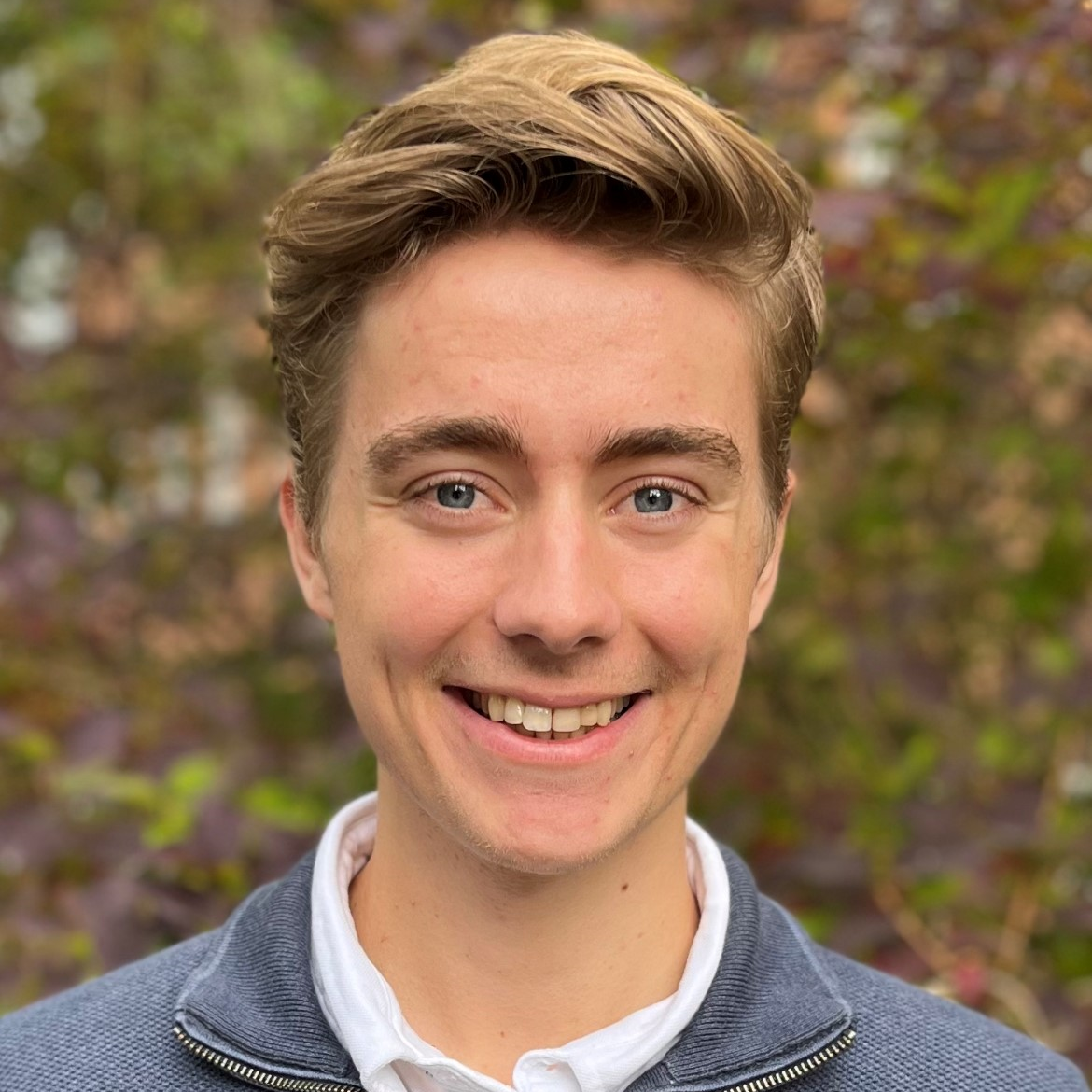 blonde man with green background