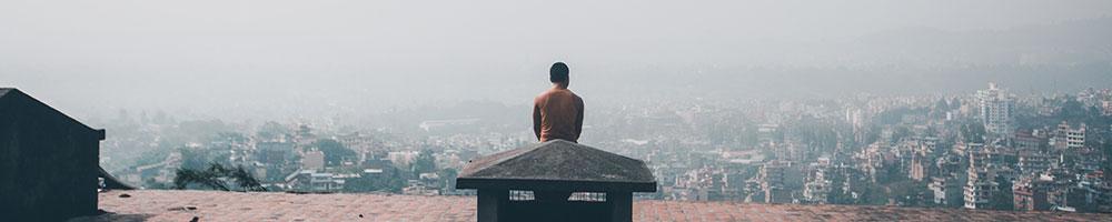 Man sitting on a roof. Photo: Pexels